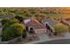 Aerial view of a single-Gathering home featuring desert landscaping, solar panels, and a three-car garage at 22432 N 52Nd Pl, Phoenix, AZ 85054