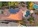 Aerial view of a desert home with a pool, solar panels, and green landscaping at 22432 N 52Nd Pl, Phoenix, AZ 85054
