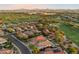 Aerial view of homes in a golf course community with mountain views at 22432 N 52Nd Pl, Phoenix, AZ 85054
