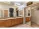Spacious bathroom with a double vanity, large mirror, and tile flooring with a closet for storage at 22432 N 52Nd Pl, Phoenix, AZ 85054