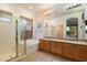 Well-lit bathroom featuring a separate glass shower, soaking tub, and double sink vanity at 22432 N 52Nd Pl, Phoenix, AZ 85054