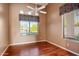 Cozy bedroom with wood floors, stylish window treatments, and plenty of natural light at 22432 N 52Nd Pl, Phoenix, AZ 85054