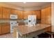 Spacious kitchen with island, white appliances, and granite counters at 22432 N 52Nd Pl, Phoenix, AZ 85054