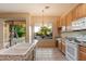 Charming kitchen with views to the pool and back landscaping at 22432 N 52Nd Pl, Phoenix, AZ 85054