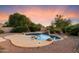 Backyard pool with desert landscaping, a rock waterfall feature, and desert animal art at 22432 N 52Nd Pl, Phoenix, AZ 85054