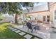 Beautiful backyard featuring a tiled fire pit, seating area, and lush landscaping perfect for outdoor entertaining at 2316 N 81St St, Scottsdale, AZ 85257