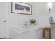 Bright bathroom features a soaking tub with decorative tile surround and classic fixtures under a landscape art piece at 2316 N 81St St, Scottsdale, AZ 85257