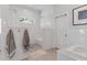 An elegant walk-in shower with dual showerheads, mosaic flooring, and a built-in bench alongside the soaking tub at 2316 N 81St St, Scottsdale, AZ 85257