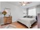 Bright bedroom with hardwood floors, ornate wood dresser, and natural light streaming through the windows at 2316 N 81St St, Scottsdale, AZ 85257