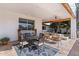 Inviting covered patio with an outdoor dining set, lounge chairs, and a view of the well-maintained backyard at 2316 N 81St St, Scottsdale, AZ 85257