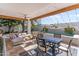 Charming covered patio featuring a comfortable seating area, dining table, and a view of the sparkling pool and lush landscaping at 2316 N 81St St, Scottsdale, AZ 85257