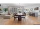 Open-concept dining area with hardwood floors, modern chandelier, and seamless flow into the living and kitchen spaces at 2316 N 81St St, Scottsdale, AZ 85257