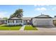 Charming single-story home with well-manicured lawn, an attached garage, and a cozy seating area by the front door at 2316 N 81St St, Scottsdale, AZ 85257