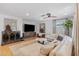 Well-lit living room with hardwood floors, a sectional sofa, a round coffee table, and stylish furnishings at 2316 N 81St St, Scottsdale, AZ 85257