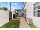 Functional side yard with a paved walkway, built-in grill, and shaded seating area for outdoor cooking and relaxation at 2316 N 81St St, Scottsdale, AZ 85257