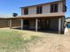Exterior rear view of house showcasing covered patio space and grassy yard ready for personalization at 23833 N 36Th Dr, Glendale, AZ 85310