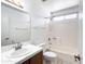 Well-lit bathroom featuring a sink, shower-tub combo and neutral tile at 23833 N 36Th Dr, Glendale, AZ 85310