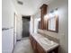 Bright bathroom featuring a dual sink vanity and a glass-enclosed shower at 23833 N 36Th Dr, Glendale, AZ 85310
