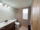 Cozy bathroom with a wooden vanity, oval sink, and tiled floor at 23833 N 36Th Dr, Glendale, AZ 85310