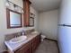 Double sink vanity in a bright bathroom featuring tile countertops, wood cabinetry, and chrome fixtures at 23833 N 36Th Dr, Glendale, AZ 85310
