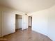 This bedroom has wood-look flooring and ample closet space for storage at 23833 N 36Th Dr, Glendale, AZ 85310