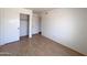 This bedroom has wood-look flooring and ample closet space for storage at 23833 N 36Th Dr, Glendale, AZ 85310