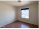 Cozy bedroom with a window and wood-look laminate flooring at 23833 N 36Th Dr, Glendale, AZ 85310