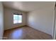 This bedroom features wood-look flooring and a window for natural light at 23833 N 36Th Dr, Glendale, AZ 85310