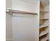 Walk-in closet featuring adjustable shelving and a sturdy wooden hanging rod for optimal organization at 23833 N 36Th Dr, Glendale, AZ 85310