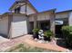 Inviting front porch with brick accents and lush landscaping creates a welcoming entrance at 23833 N 36Th Dr, Glendale, AZ 85310