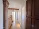 Hallway with wooden railing featuring a built-in dark wood storage cabinet at 23833 N 36Th Dr, Glendale, AZ 85310