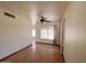 Bright living room with wood floors, ceiling fan, large window, and neutral paint at 23833 N 36Th Dr, Glendale, AZ 85310