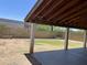 Covered patio features concrete flooring, sturdy support pillars, and a view of the large, fenced backyard at 23833 N 36Th Dr, Glendale, AZ 85310
