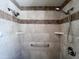 Custom shower with a built-in bench, multiple shower heads, and stylish tile at 23833 N 36Th Dr, Glendale, AZ 85310