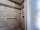 Custom shower with built in shelves, a safety bar and two shower heads at 23833 N 36Th Dr, Glendale, AZ 85310