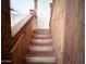 Wooden staircase with a rustic wooden accent wall, complemented by a matching wooden handrail at 23833 N 36Th Dr, Glendale, AZ 85310