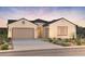 Beautiful single-story home with a neutral color scheme, manicured landscaping, and a two-car garage at 24819 N 169Th Dr, Surprise, AZ 85387