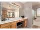 Bright and airy main bathroom vanity with stool, and large mirror at 26272 N 73Rd Dr, Peoria, AZ 85383