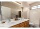 This bathroom features a double sink vanity, a large mirror, and a shower and tub combo at 26272 N 73Rd Dr, Peoria, AZ 85383