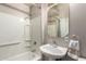 Cozy bathroom featuring a shower and bath, a mirror and a sink with a towel hanging nearby at 26272 N 73Rd Dr, Peoria, AZ 85383