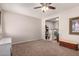 Bedroom with tan carpet and walls, featuring a view into an office space, for versatile living at 26272 N 73Rd Dr, Peoria, AZ 85383