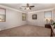 Large bedroom with neutral carpet, two windows, and ceiling fan at 26272 N 73Rd Dr, Peoria, AZ 85383