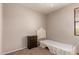 Bedroom with brown wood dresser, bed, and window that provides natural light at 26272 N 73Rd Dr, Peoria, AZ 85383