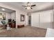 Spacious bedroom with an ensuite office, carpet flooring, and generous closet space for comfortable living at 26272 N 73Rd Dr, Peoria, AZ 85383