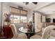 Bright dining area features a glass table, four upholstered chairs, and an adjacent living space at 26272 N 73Rd Dr, Peoria, AZ 85383