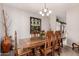 Formal dining room showcasing a chandelier and an ornate wood dining table and chairs at 26272 N 73Rd Dr, Peoria, AZ 85383