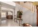 Bright foyer featuring tile floors, a staircase, and an elegant console table at 26272 N 73Rd Dr, Peoria, AZ 85383