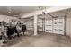 This garage offers ample storage with extensive shelving and multiple garage door access at 26272 N 73Rd Dr, Peoria, AZ 85383