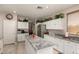 Lovely kitchen with white cabinets, granite countertops, tile flooring, and stainless steel appliances at 26272 N 73Rd Dr, Peoria, AZ 85383
