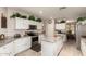 Bright eat-in kitchen with white cabinets, granite countertops, stainless steel appliances, and center island at 26272 N 73Rd Dr, Peoria, AZ 85383
